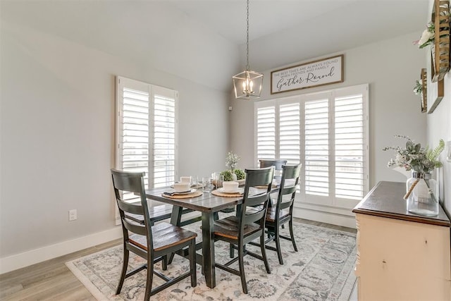 10125 NW 99th St, Yukon, OK 73099 - dining room featuring light wood-style floors, a chandelier, and lofted ceiling