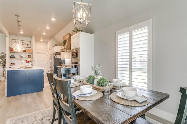 10125 NW 99th St, Yukon, OK 73099 - dining room with light wood-style floors, a chandelier, and recessed lighting