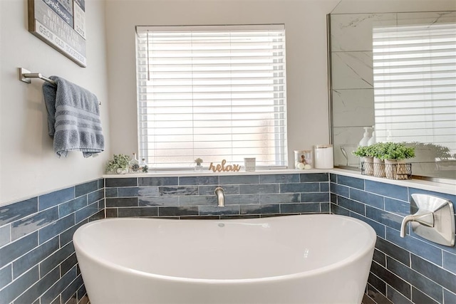 10125 NW 99th St, Yukon, OK 73099 - full bathroom featuring tile walls, a freestanding tub, plenty of natural light, and wainscoting