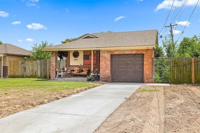 807 Thompson Dr, El Reno, OK 73036 - ranch-style house with brick siding, concrete driveway, covered porch, roof with shingles, and a garage