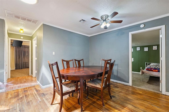807 Thompson Dr, El Reno, OK 73036 - dining area featuring wood-type flooring, a ceiling fan, a textured ceiling, and crown molding