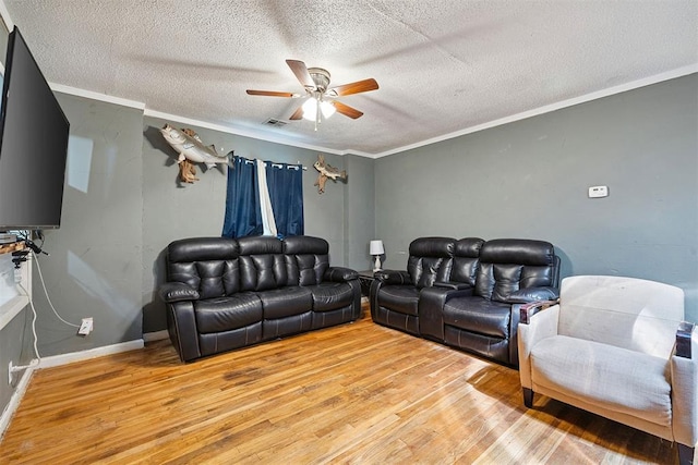 807 Thompson Dr, El Reno, OK 73036 - living room featuring wood finished floors, ceiling fan, ornamental molding, and a textured ceiling