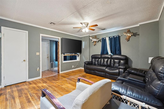 807 Thompson Dr, El Reno, OK 73036 - living area with ceiling fan, hardwood / wood-style flooring, crown molding, and a textured ceiling
