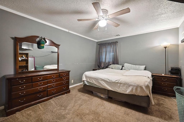807 Thompson Dr, El Reno, OK 73036 - carpeted bedroom featuring a textured ceiling, ornamental molding, and ceiling fan