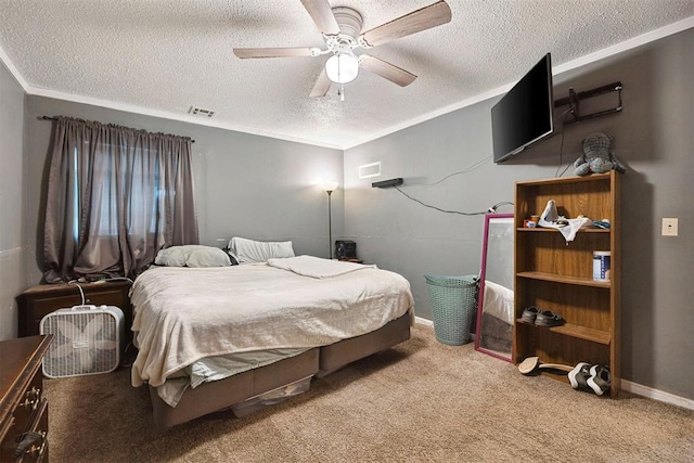 807 Thompson Dr, El Reno, OK 73036 - bedroom with a textured ceiling, carpet floors, ceiling fan, and ornamental molding