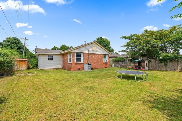 807 Thompson Dr, El Reno, OK 73036 - rear view of property with a trampoline, brick siding, a fenced backyard, and crawl space