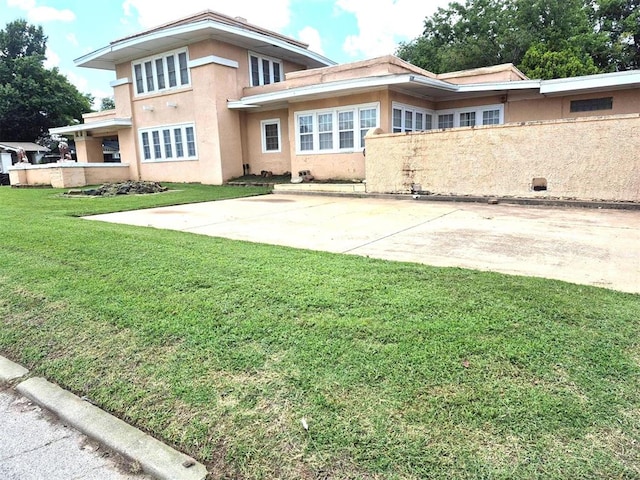 4300 N Butler Pl, Oklahoma City, OK 73118 - rear view of house featuring stucco siding, a yard, and a patio area