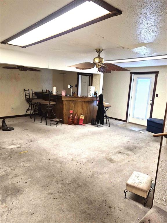 4300 N Butler Pl, Oklahoma City, OK 73118 - living room with unfinished concrete floors and ceiling fan