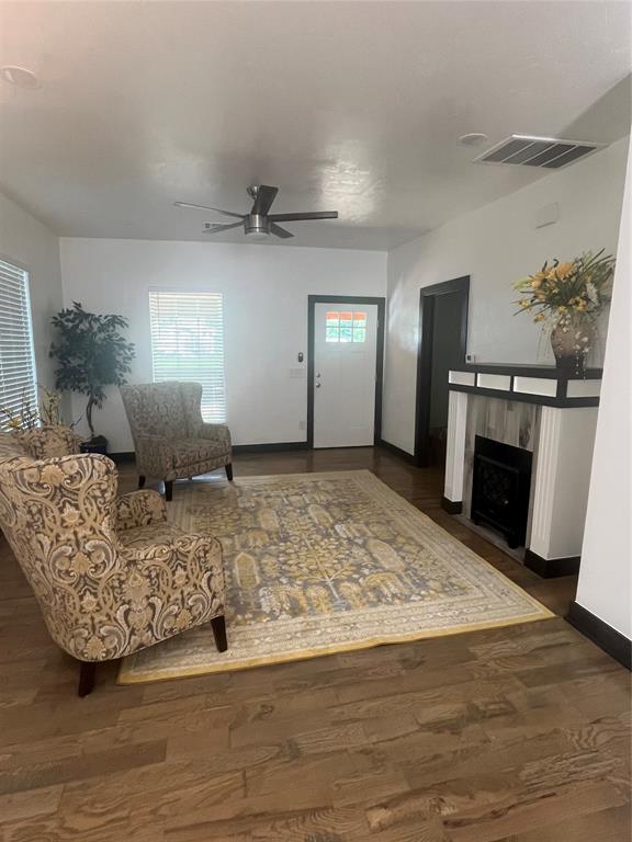 2416 S Shartel Ave, Oklahoma City, OK 73109 - living area with healthy amount of natural light, a ceiling fan, and wood finished floors