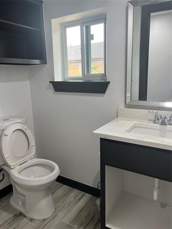 2416 S Shartel Ave, Oklahoma City, OK 73109 - bathroom with vanity and wood finished floors