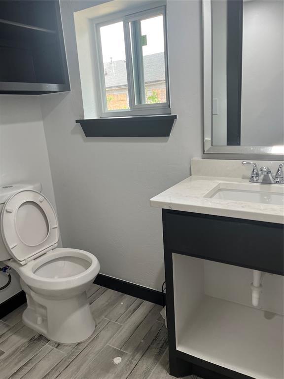 2416 S Shartel Ave, Oklahoma City, OK 73109 - bathroom with vanity and wood finished floors