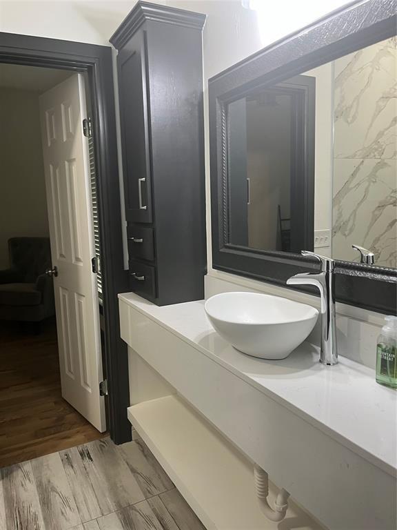 2416 S Shartel Ave, Oklahoma City, OK 73109 - bathroom with vanity and wood finished floors