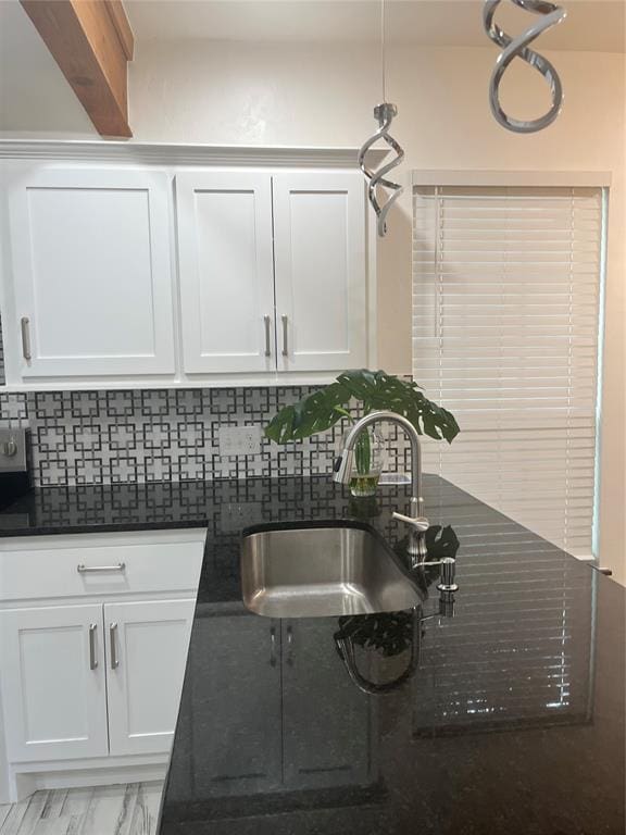 2416 S Shartel Ave, Oklahoma City, OK 73109 - kitchen featuring backsplash, white cabinets, and dark stone countertops