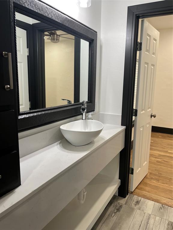2416 S Shartel Ave, Oklahoma City, OK 73109 - bathroom with vanity and wood finished floors