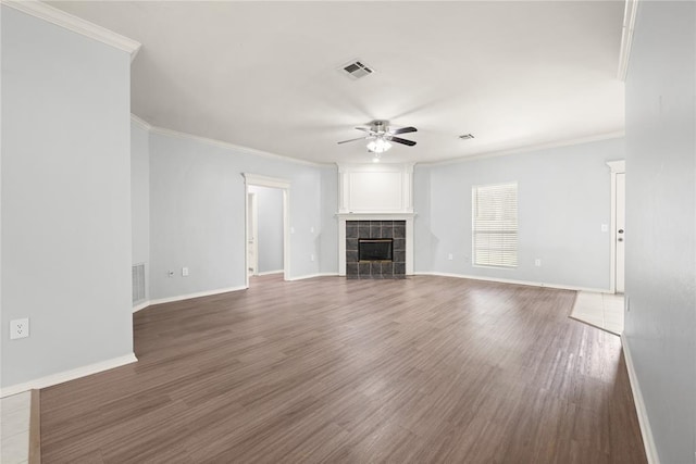 544 NW 172nd Pl Unit 8015998877, Edmond, OK 73012 - unfurnished living room with a ceiling fan, crown molding, a tiled fireplace, and wood finished floors