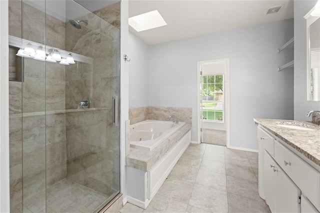 544 NW 172nd Pl Unit 8015998877, Edmond, OK 73012 - bathroom featuring a skylight, a stall shower, a tub with jets, and vanity