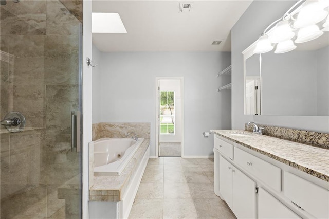 544 NW 172nd Pl Unit 8015998877, Edmond, OK 73012 - full bath with a shower stall, a tub with jets, vanity, tile patterned floors, and a skylight