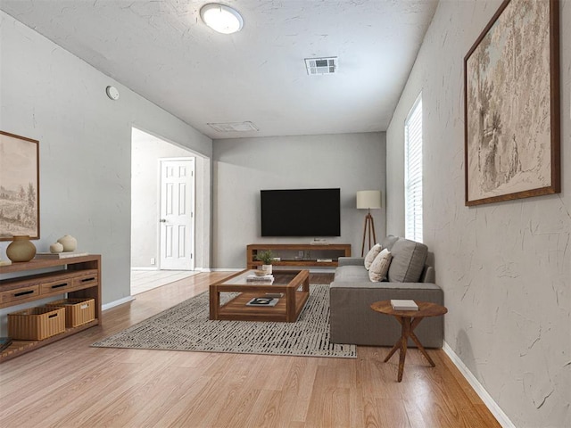 6604 NW 32nd St, Bethany, OK 73008 - living room featuring wood finished floors and a textured wall