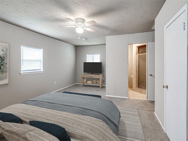 6604 NW 32nd St, Bethany, OK 73008 - bedroom with multiple windows, carpet floors, ceiling fan, and ensuite bath