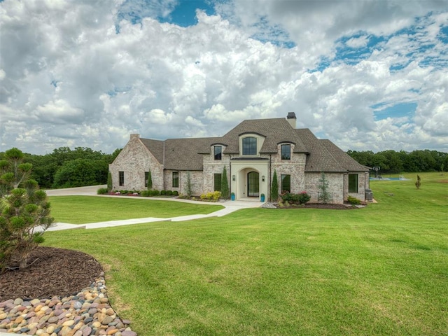 19890 Hickory Ridge Rd, Arcadia, OK 73007 - french country home with stone siding, a chimney, and a front yard