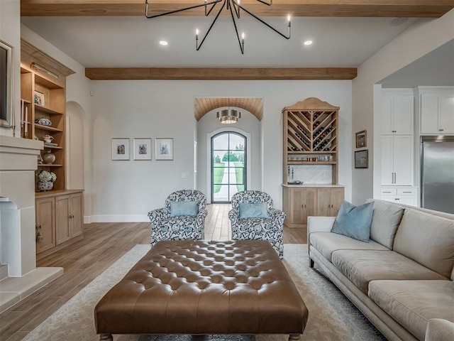 19890 Hickory Ridge Rd, Arcadia, OK 73007 - living room with beamed ceiling, light wood finished floors, arched walkways, a chandelier, and recessed lighting
