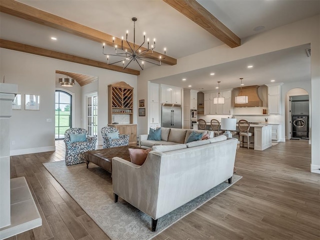 19890 Hickory Ridge Rd, Arcadia, OK 73007 - living area with washer / dryer, beamed ceiling, wood finished floors, a chandelier, and arched walkways