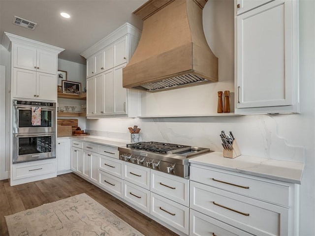 19890 Hickory Ridge Rd, Arcadia, OK 73007 - kitchen with custom exhaust hood, open shelves, stainless steel appliances, white cabinetry, and dark wood-style flooring