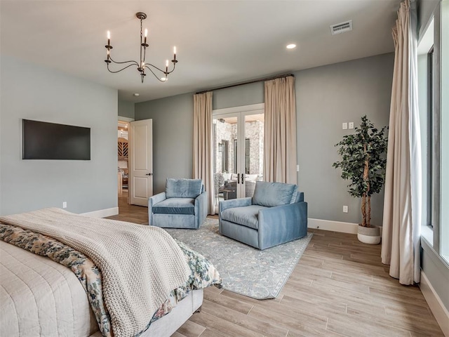 19890 Hickory Ridge Rd, Arcadia, OK 73007 - bedroom with a chandelier, recessed lighting, light wood-type flooring, and french doors