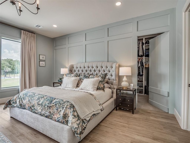 19890 Hickory Ridge Rd, Arcadia, OK 73007 - bedroom with a decorative wall, recessed lighting, a spacious closet, light wood finished floors, and a closet