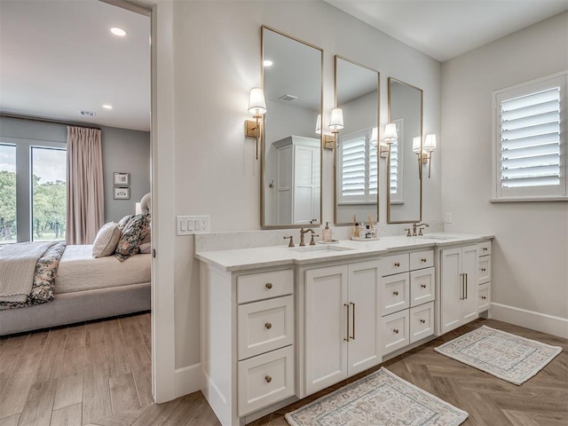 19890 Hickory Ridge Rd, Arcadia, OK 73007 - bathroom featuring connected bathroom, double vanity, recessed lighting, and wood finished floors