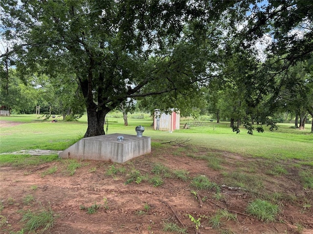 4620 SE 119th St, Oklahoma City, OK 73165 - view of green lawn with a storage unit and view of wooded area