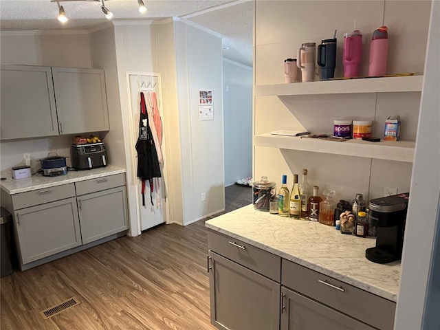 4620 SE 119th St, Oklahoma City, OK 73165 - kitchen with ornamental molding, gray cabinetry, open shelves, wood finished floors, and a textured ceiling