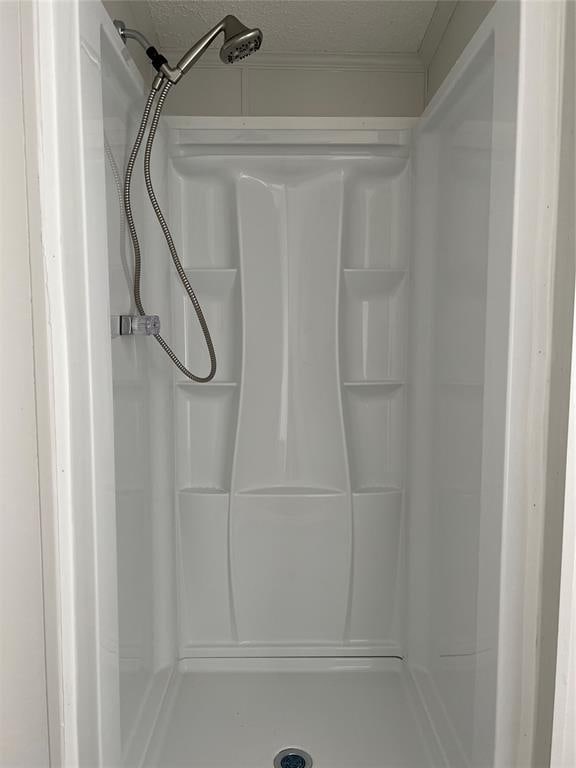 4620 SE 119th St, Oklahoma City, OK 73165 - bathroom with a shower stall and a textured ceiling