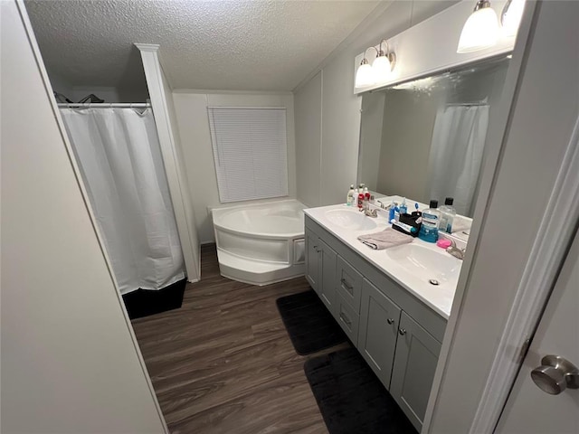 4620 SE 119th St, Oklahoma City, OK 73165 - full bathroom with wood finished floors, double vanity, a bath, a textured ceiling, and a shower with shower curtain