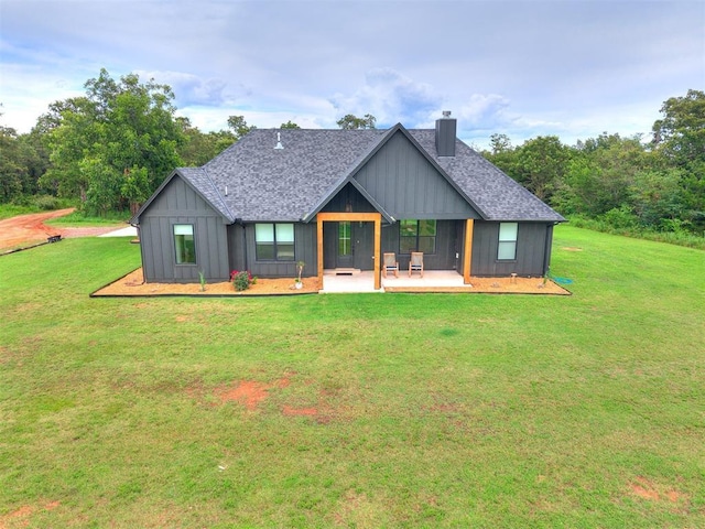 11275 S Henney Rd, Meridian, OK 73058 - rear view of house with a chimney, a shingled roof, a yard, and a patio