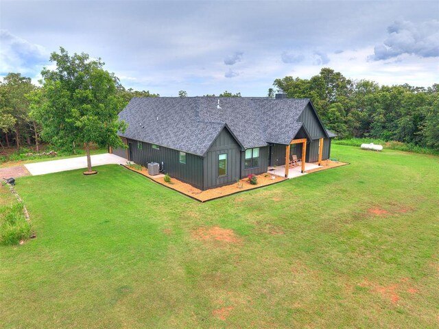11275 S Henney Rd, Meridian, OK 73058 - modern farmhouse style home with a front yard, driveway, a shingled roof, and board and batten siding