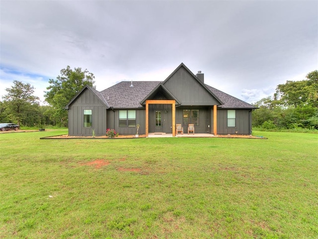 11275 S Henney Rd, Meridian, OK 73058 - rear view of property with a chimney, a lawn, a patio, and roof with shingles