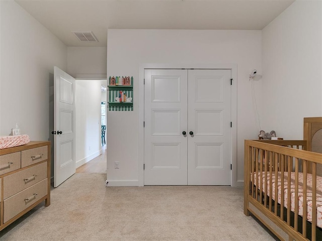 11275 S Henney Rd, Meridian, OK 73058 - bedroom with light carpet, a closet, and a crib