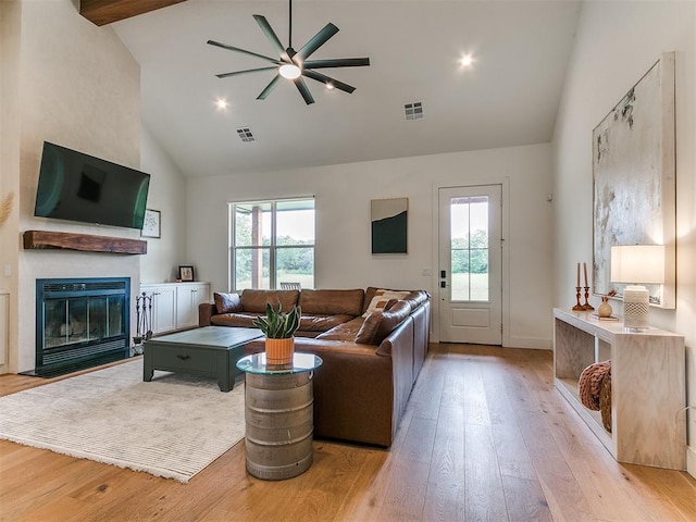 11275 S Henney Rd, Meridian, OK 73058 - living area with high vaulted ceiling, ceiling fan, light wood-type flooring, and a glass covered fireplace