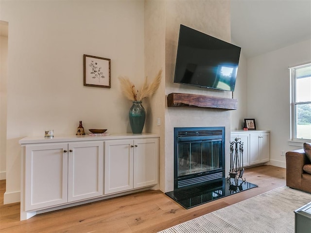 11275 S Henney Rd, Meridian, OK 73058 - living area featuring light wood-style floors and a glass covered fireplace