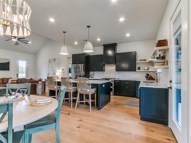 11275 S Henney Rd, Meridian, OK 73058 - kitchen with appliances with stainless steel finishes, premium range hood, light countertops, open shelves, and vaulted ceiling