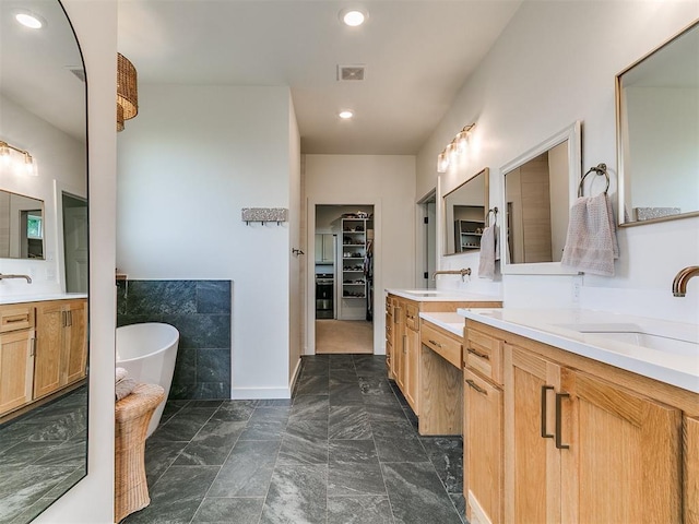 11275 S Henney Rd, Meridian, OK 73058 - full bath featuring vanity, a freestanding bath, a spacious closet, and recessed lighting