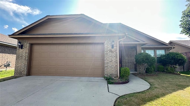 ranch-style home featuring a garage, brick siding, concrete driveway, and a front lawn