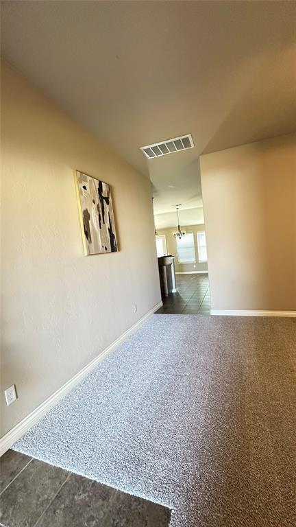 unfurnished living room featuring baseboards