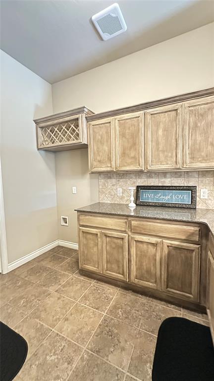 kitchen with backsplash and stone finish flooring