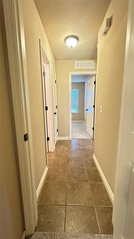 corridor featuring baseboards