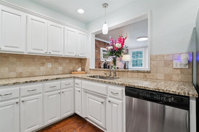 2633 Chaucer Dr, The Village, OK 73120 - kitchen with stainless steel dishwasher, tasteful backsplash, white cabinets, light stone counters, and dark wood-style floors