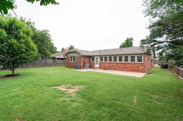 2633 Chaucer Dr, The Village, OK 73120 - rear view of house featuring brick siding, a patio, a fenced backyard, and a chimney