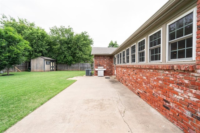 2633 Chaucer Dr, The Village, OK 73120 - fenced backyard with a patio, a storage unit, and grilling area