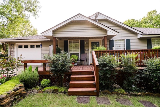 207 S Mcclure Ave, Pauls Valley, OK 73075 - view of front of house featuring an attached garage, a porch, and a shingled roof